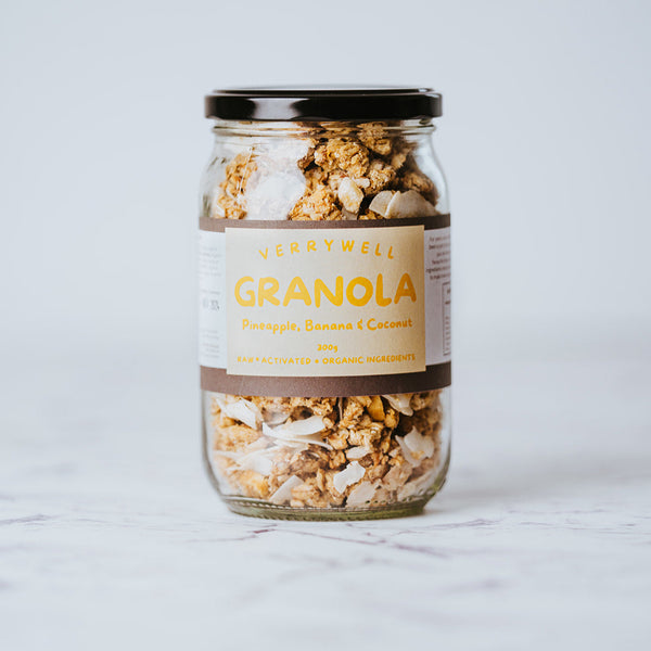 A glass jar filled with granola, with visible oats, nuts, and dried fruits, labeled 'Granola' and 'Organic'.